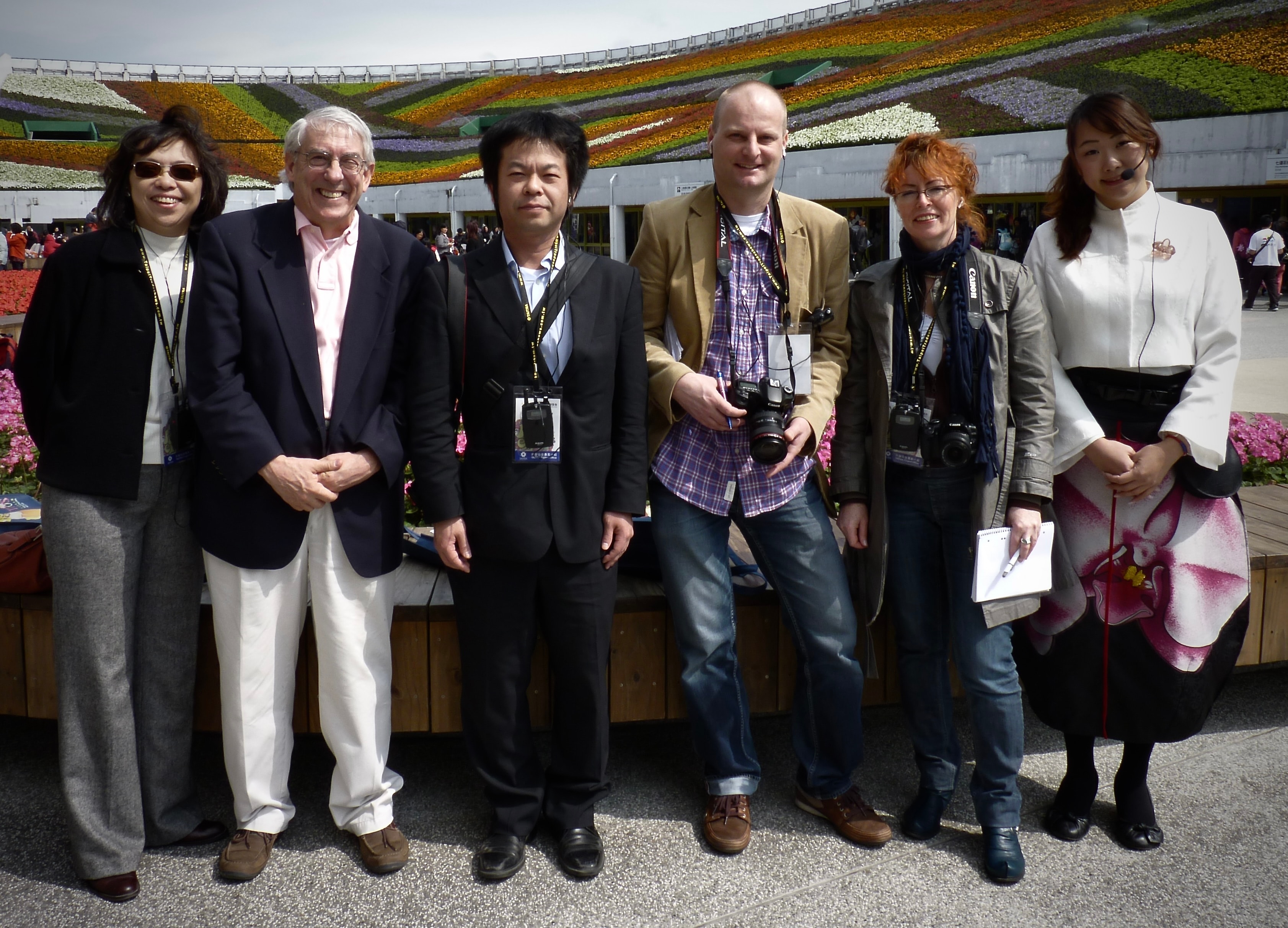 International press group at the Taipei Flora Exposition grounds with sweeping floral displays, 2011